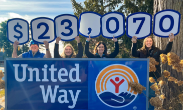 M1 team members stand in front of United Way Sign